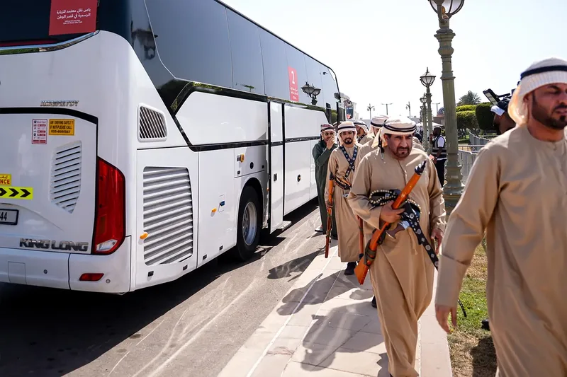 Guests walking beside event shuttle coaches