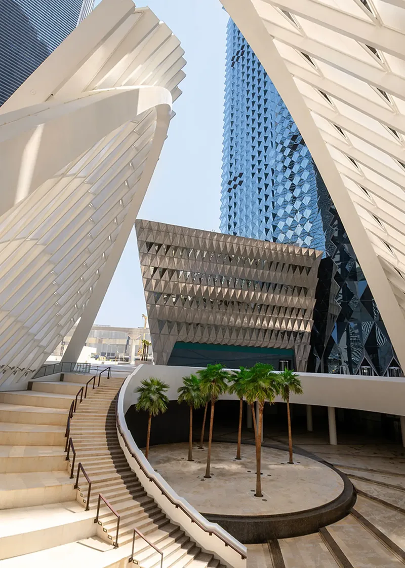 Contemporary architectural venue with geometric façade and landscaped entrance.