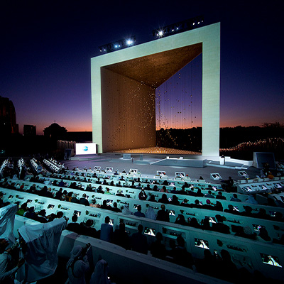 Large-scale outdoor event stage with immersive projection and audience seating