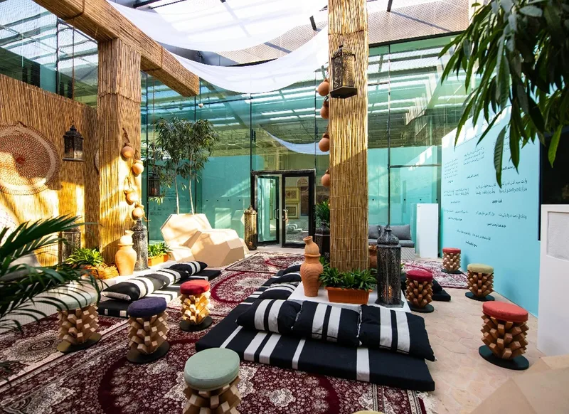 Custom majlis at Al Burda Festival with traditional rugs, low seating, cultural décor and hospitality setting