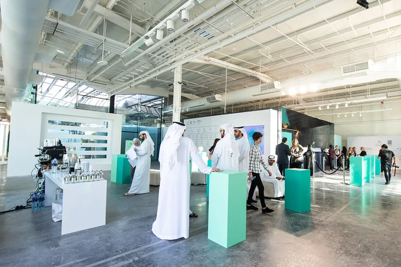 Al Burda Festival exhibition area with guests viewing cultural displays and contemporary Islamic art installations