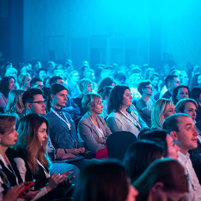 Corporate event audience attending a live business presentation