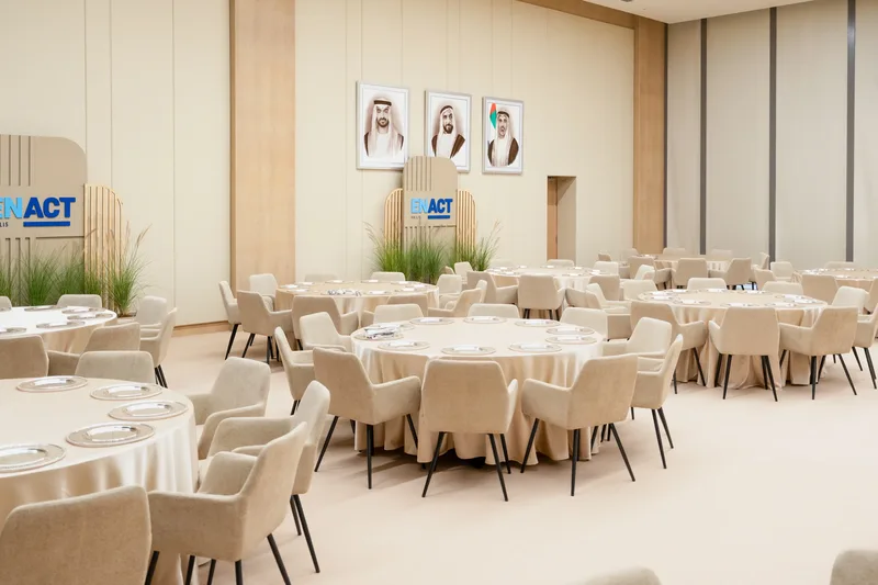 ENACT Majlis formal dining room in Abu Dhabi with round tables, neutral furniture and executive hospitality setup