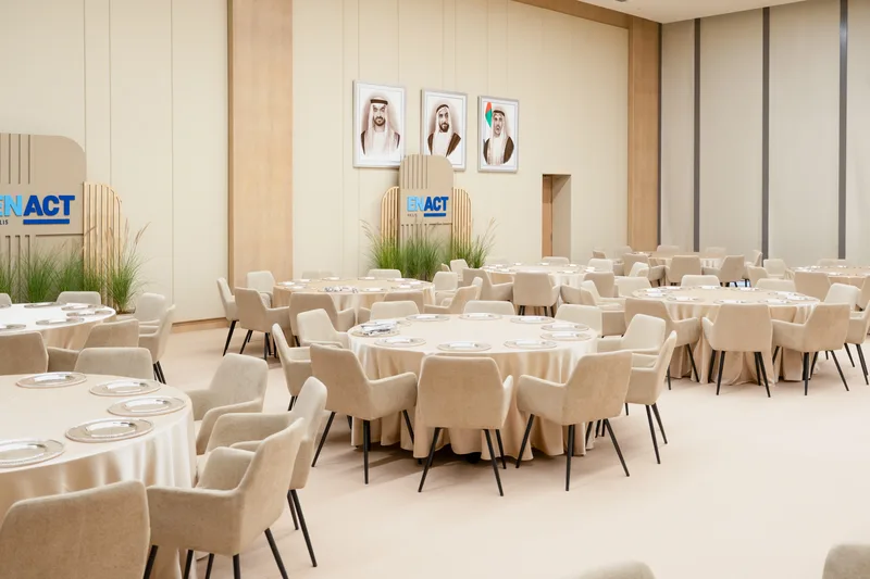 ENACT Majlis formal dining room in Abu Dhabi with round tables, neutral furniture and executive hospitality setup