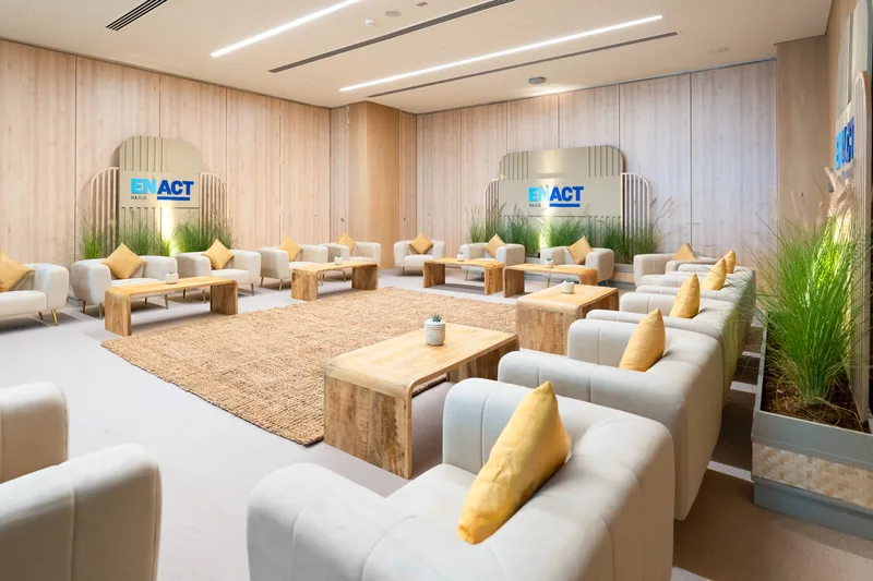 ENACT Majlis VIP lounge with contemporary furniture, soft neutral styling and branded executive meeting environment