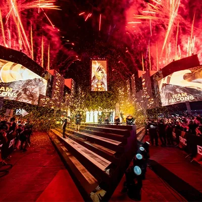 Esports World Cup 2025 central event walkway with red lighting, large digital screens and live audience