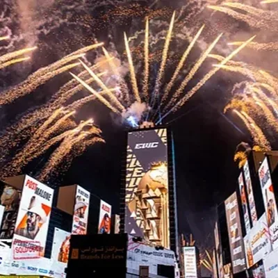 Fireworks above the Esports World Cup 2025 venue entrance and branded event towers in Riyadh