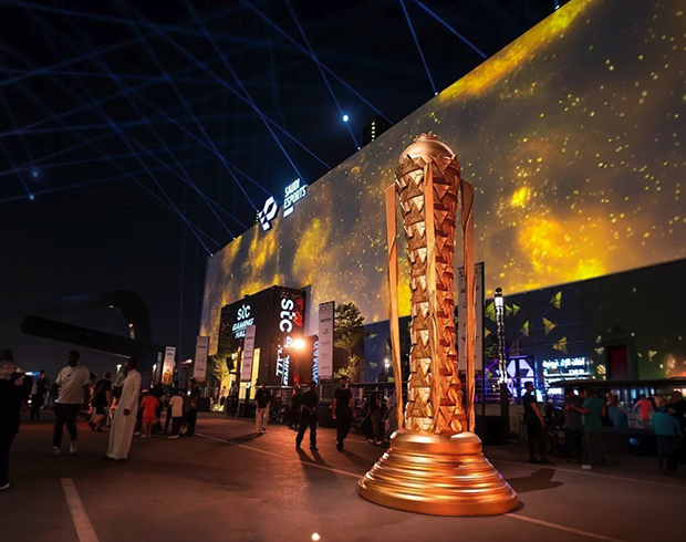 Esports World Cup 2025 venue in Riyadh with illuminated championship trophy installation, large LED façade and live event crowds