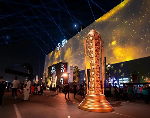 Esports World Cup 2025 venue in Riyadh with illuminated championship trophy installation, large LED façade and live event crowds
