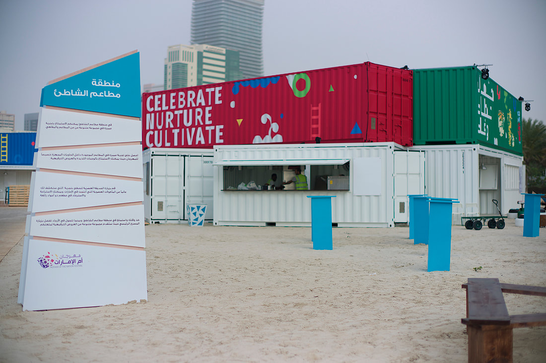 Temporary event containers and operational infrastructure being prepared behind the scenes at a festival site