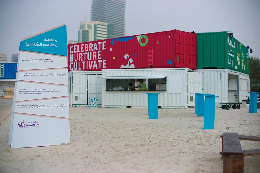 Temporary event containers and operational infrastructure being prepared behind the scenes at a festival site