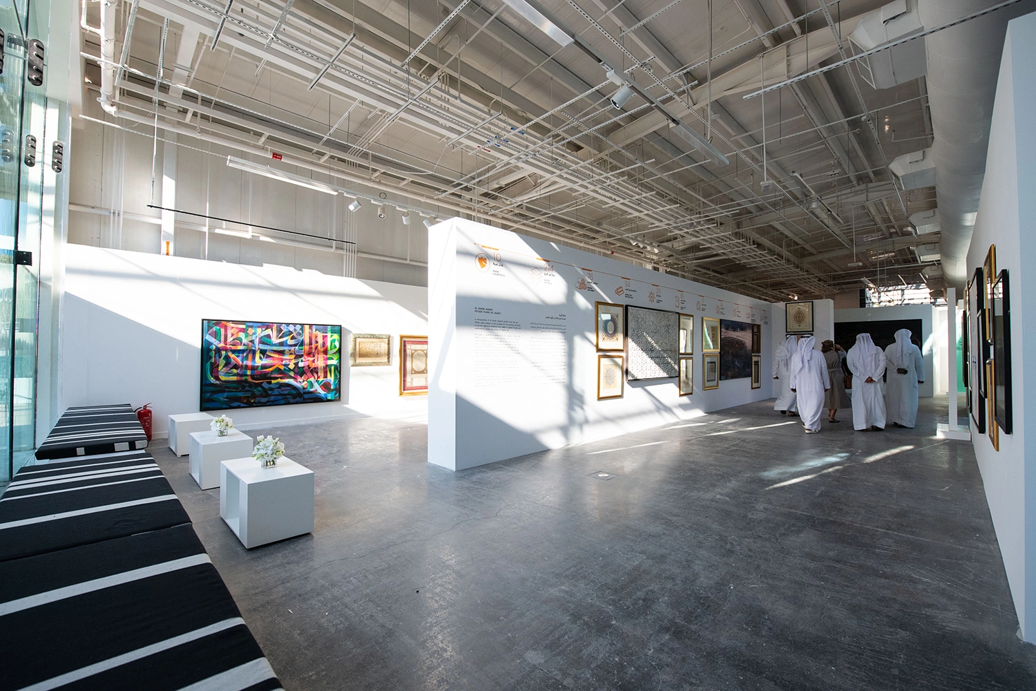 Al Burda Festival art gallery with contemporary Islamic artworks, custom exhibition walls and guest seating