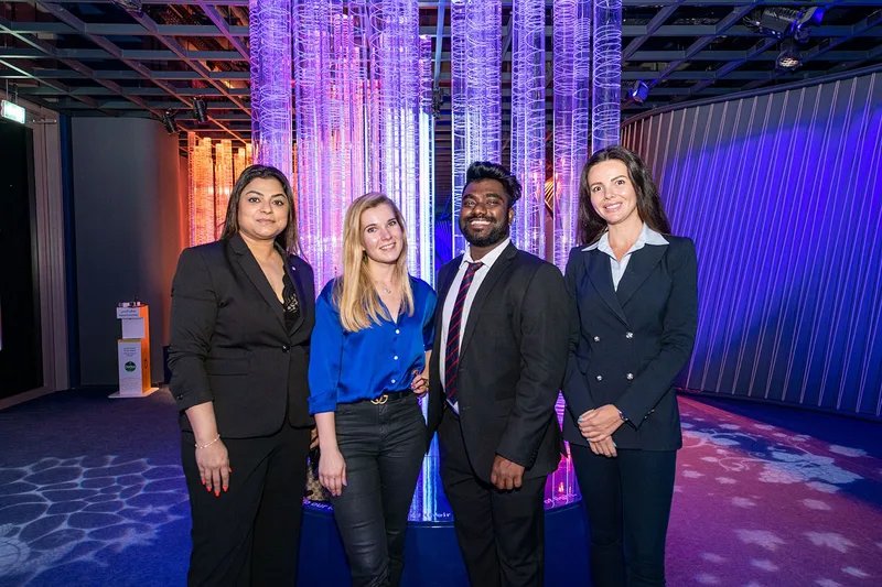 Montenegro Pavilion National Day team at Expo 2020 Dubai in front of an illuminated immersive exhibition installation