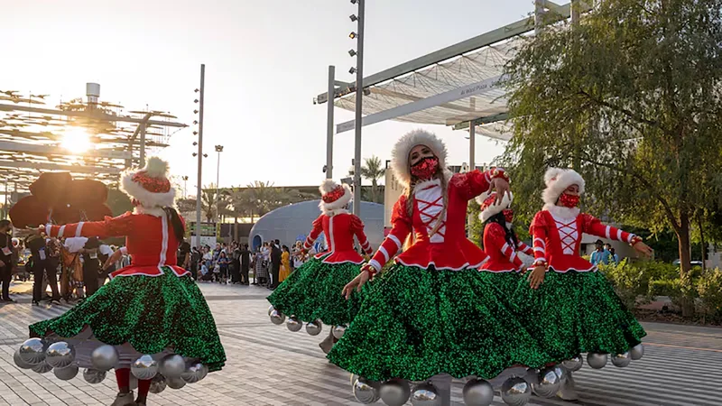 Festive Christmas performers at Expo 2020 Dubai in themed costumes during a public seasonal celebration
