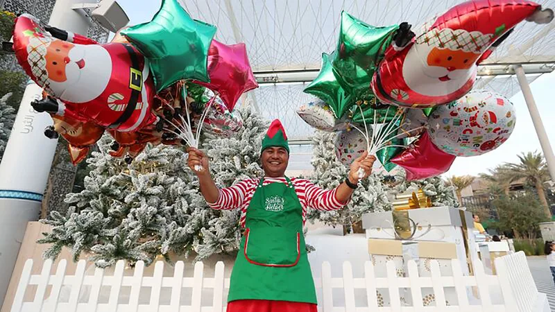 Christmas event performer at Expo 2020 Dubai with festive costume, balloons and seasonal guest entertainment