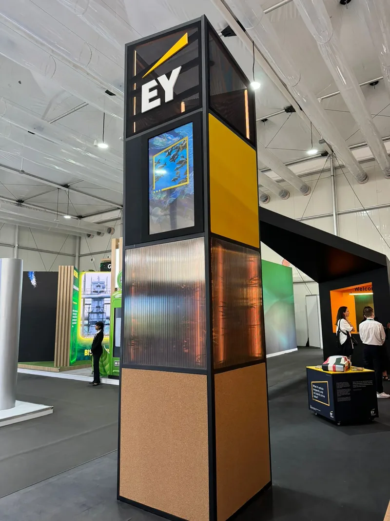 EY exhibition stand at COP28 Dubai with branded tower, digital screen and modular sustainable construction
