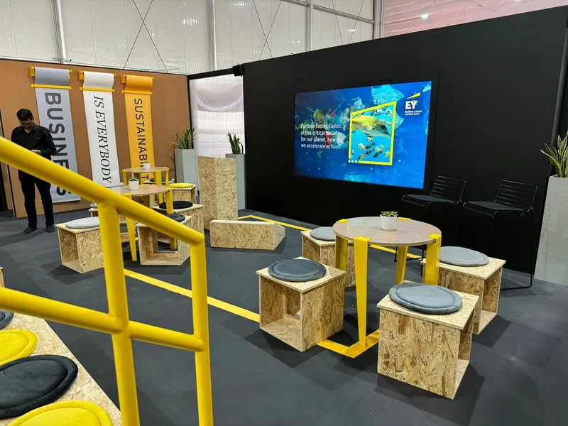 EY COP28 visitor area with sustainable furniture, interactive digital display and branded exhibition design
