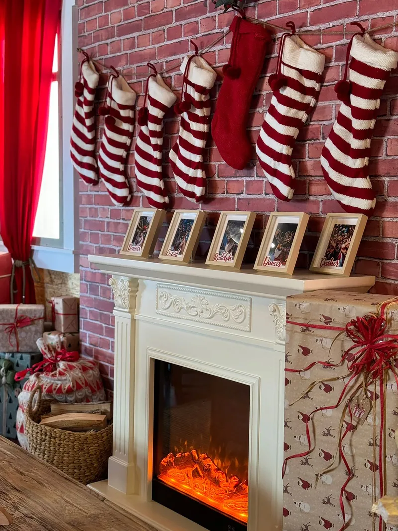 Festive Santa’s house interior with Christmas stockings, fireplace, wrapped gifts and sustainable seasonal décor