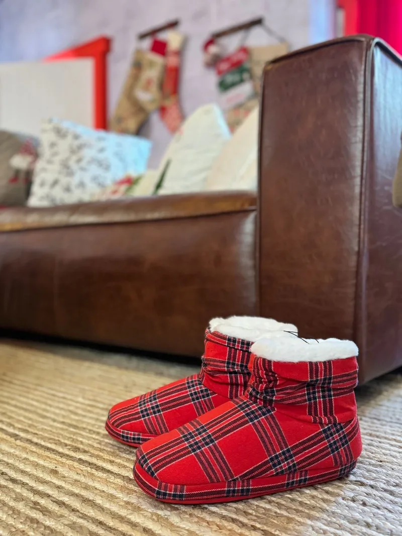 Red tartan Christmas boots displayed inside Santa’s Sustainable House as part of the festive décor