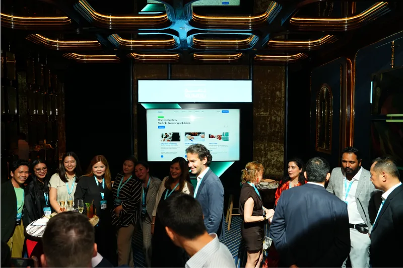 Conference networking area with delegates, digital presentation screen and guest interaction