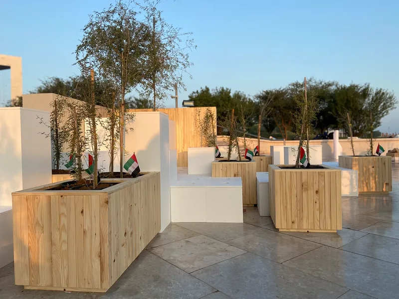 Founder’s Memorial activation with landscaped guest area, timber planters and temporary scenic structures