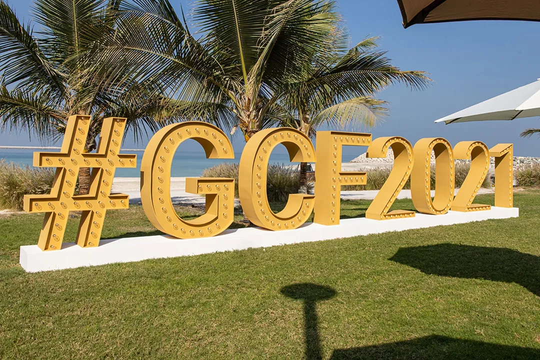 Large GCF 2021 Global Citizen Forum sign beside the beach at the Ras Al Khaimah event venue
