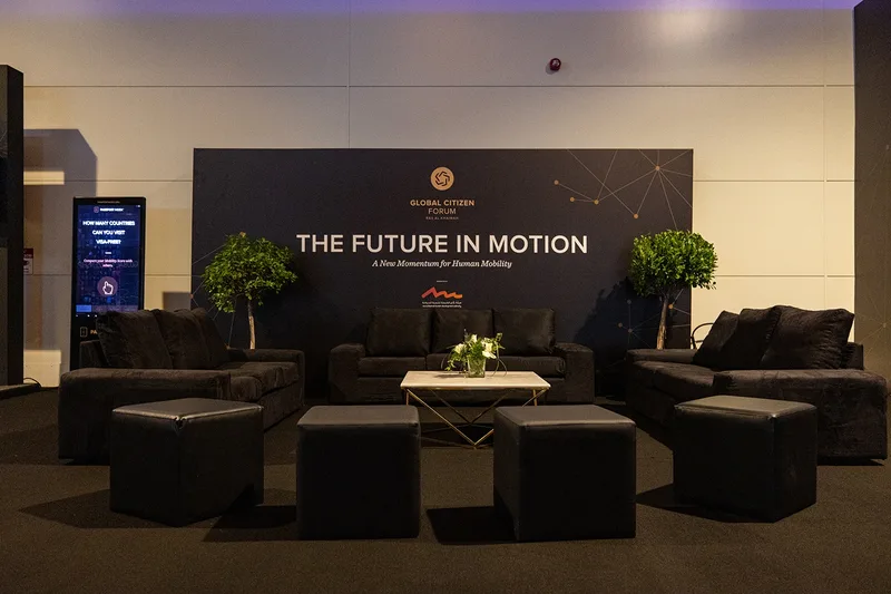 Global Citizen Forum hospitality lounge in Ras Al Khaimah with branded backdrop, black seating and guest meeting area