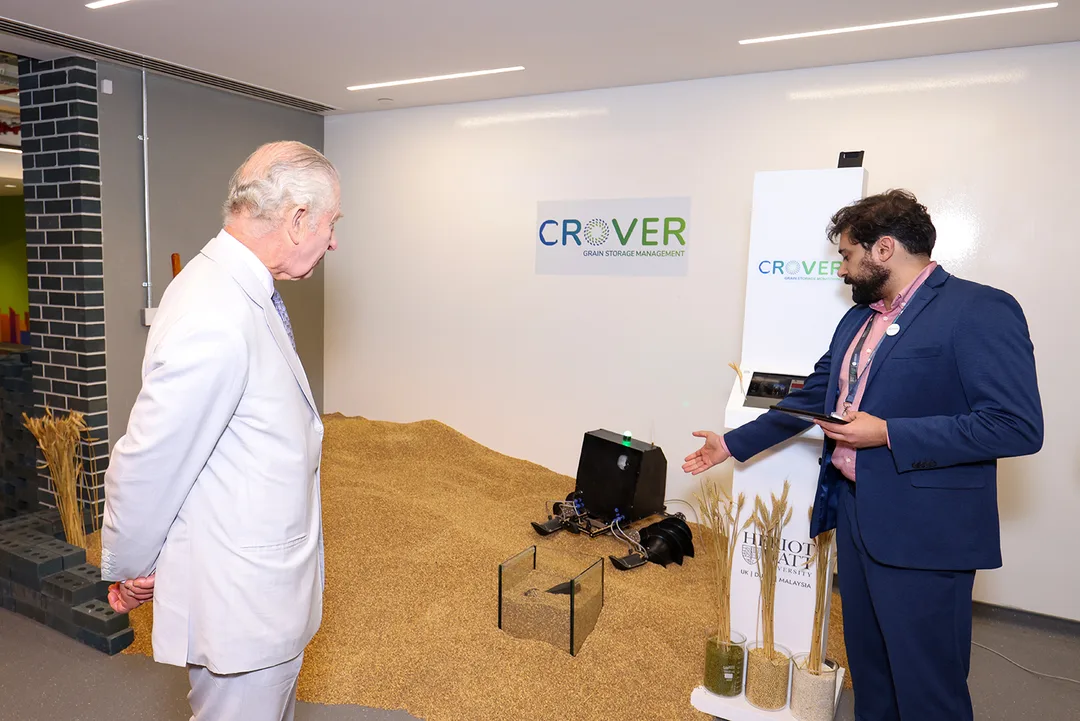 King Charles III viewing a sustainable grain-storage technology demonstration at the Heriot-Watt Climate Hub during COP28 Dubai