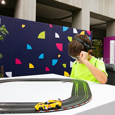 Interactive slot car racing experience at a live event activation