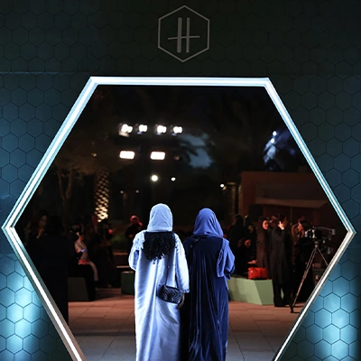 Guests entering an immersive brand experience through a custom illuminated entrance