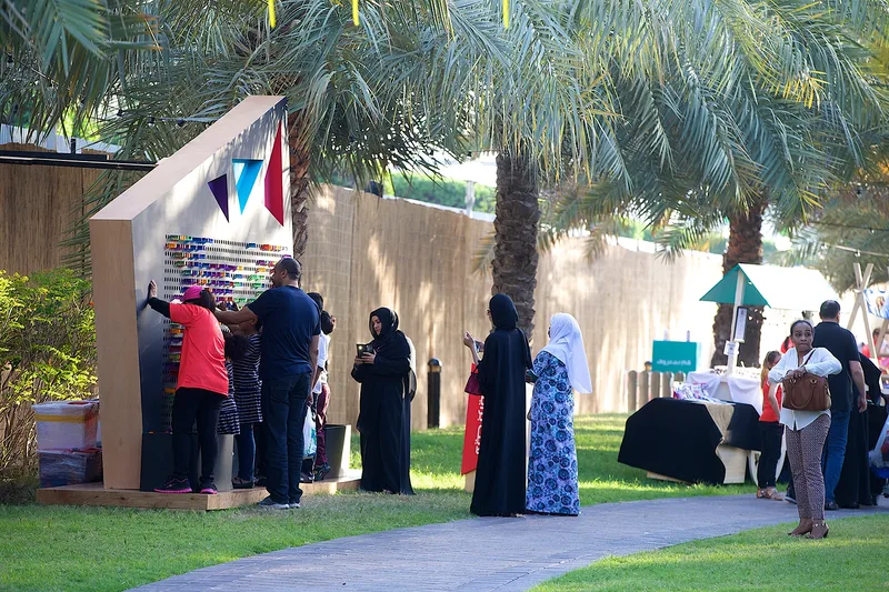 Mother of the Nation Festival community activity area with guests, temporary structures and landscaped outdoor setting