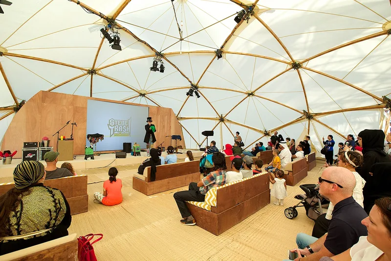 Mother of the Nation Festival workshop and discussion area inside a temporary tensile structure with seated guests