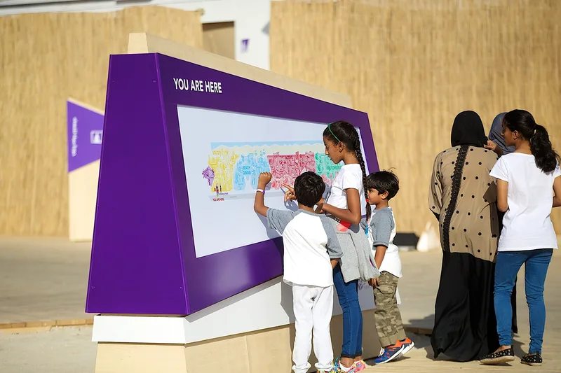 Interactive visitor engagement wall at Mother of the Nation Festival with families taking part in a public activity