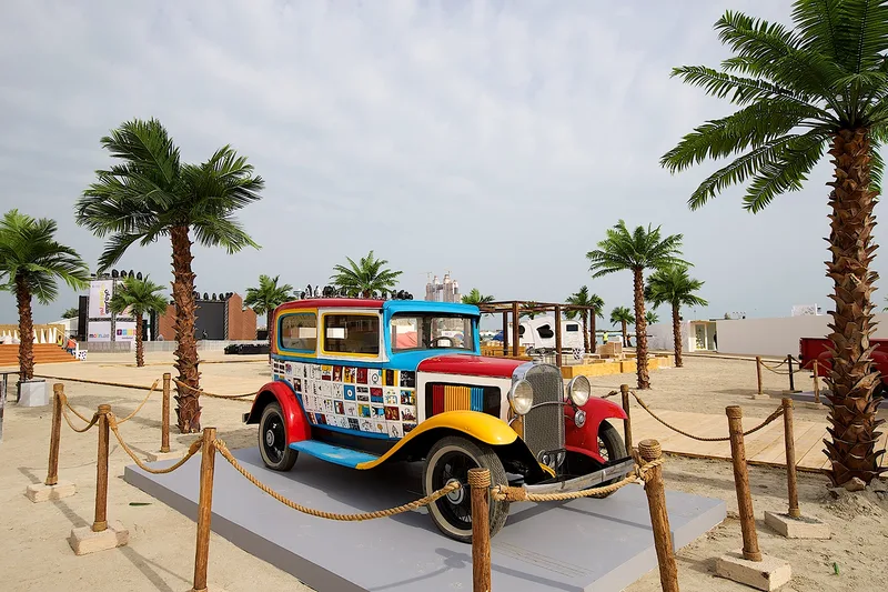 Vintage vehicle display at Mother of the Nation Festival within a themed outdoor public event environment