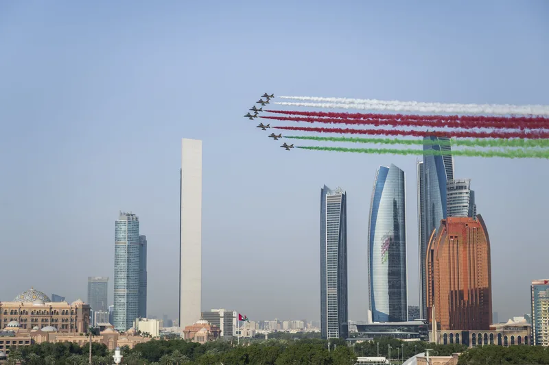 UAE Air Force flypast over Abu Dhabi during the Oman state reception with national-colour smoke trails