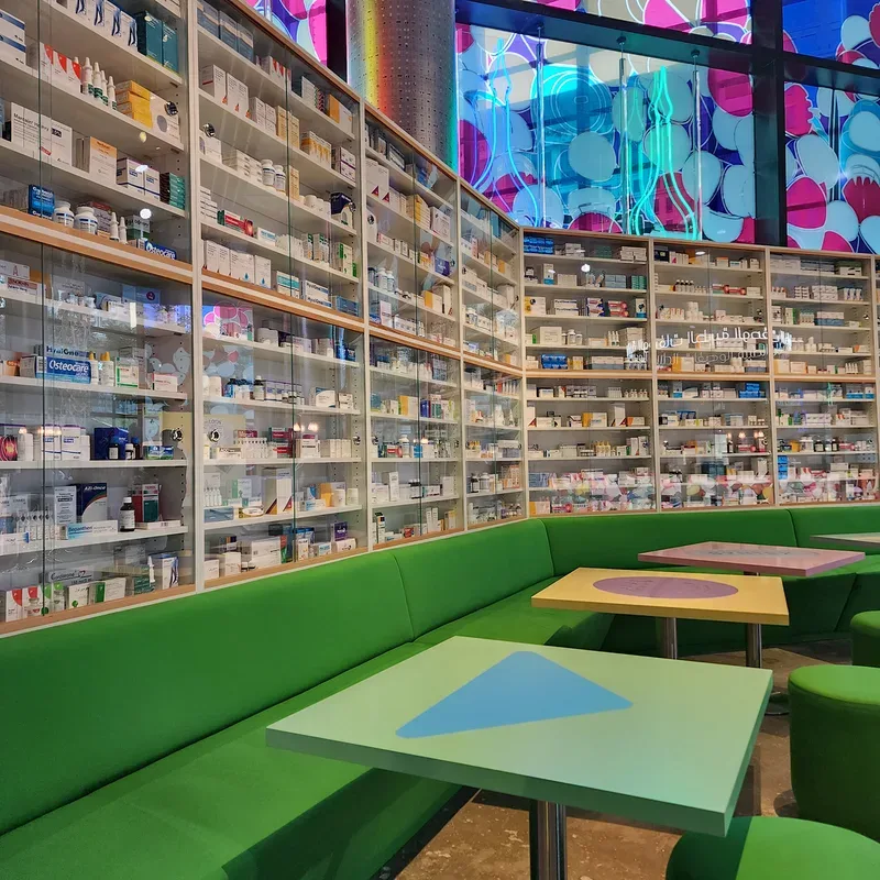 Curated experiential retail space with wall-to-wall product shelving, colourful furniture and branded interior design