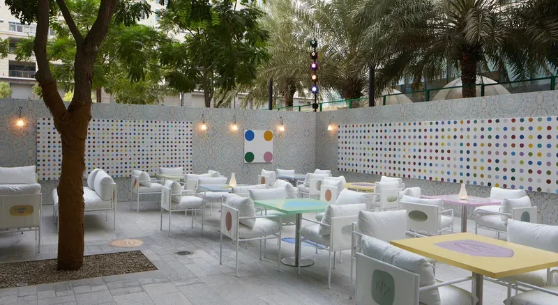 Outdoor luxury hospitality setting with contemporary furniture, decorative screens and experiential event styling