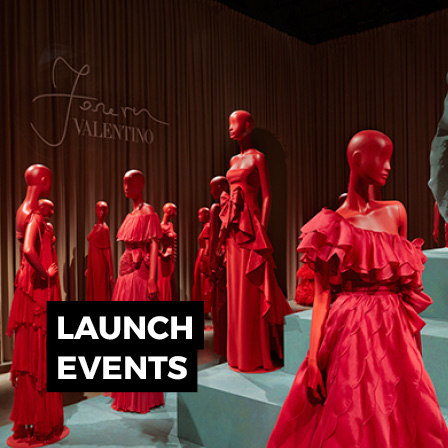 Luxury product launch with red fashion display, mannequins and branded event styling