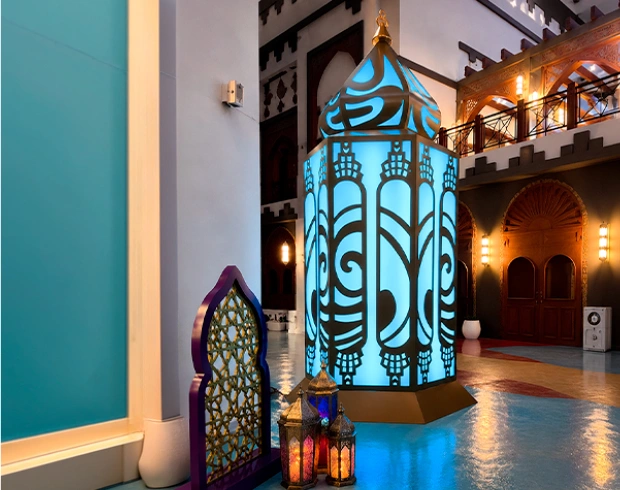 Illuminated decorative lantern installation in a heritage-style venue with scenic fabrication and event lighting