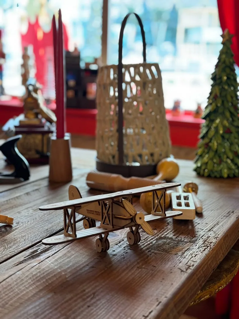 Handcrafted wooden toy aeroplane displayed as part of the sustainable Christmas workshop experience