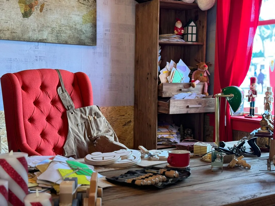 Santa’s sustainable workshop interior with handcrafted wooden toys, letters, tools and festive décor