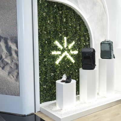 Experiential retail product display with illuminated branding