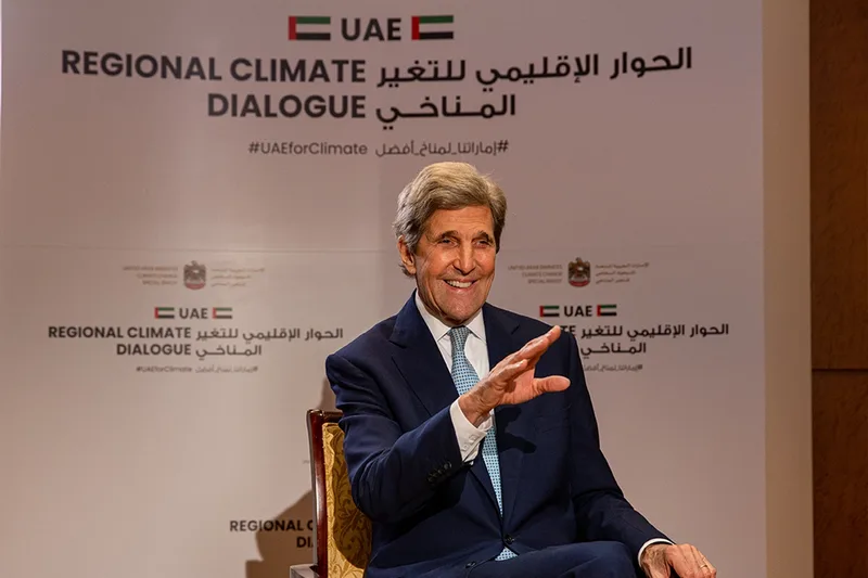 International climate dialogue speaker seated on stage at a high-level government conference in the UAE