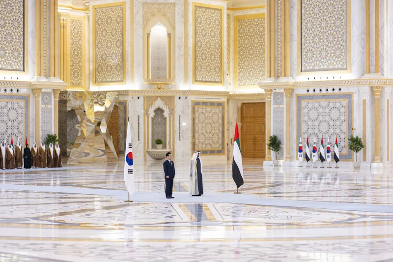 South Korean and UAE officials standing inside a formal ceremonial hall during an official state visit in Abu Dhabi