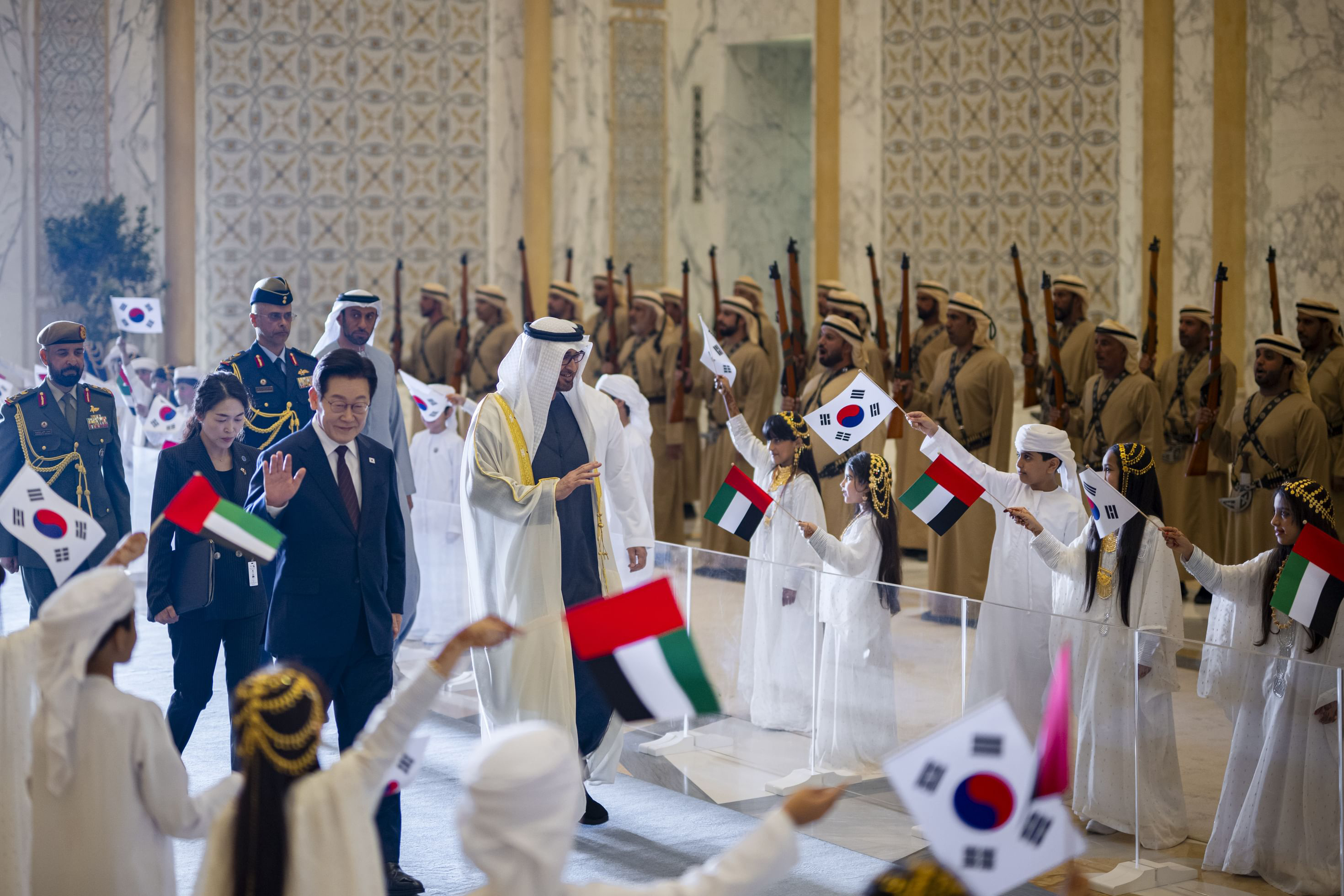 South Korean delegation welcomed during an official state visit in Abu Dhabi with Emirati children waving UAE and Korean flags