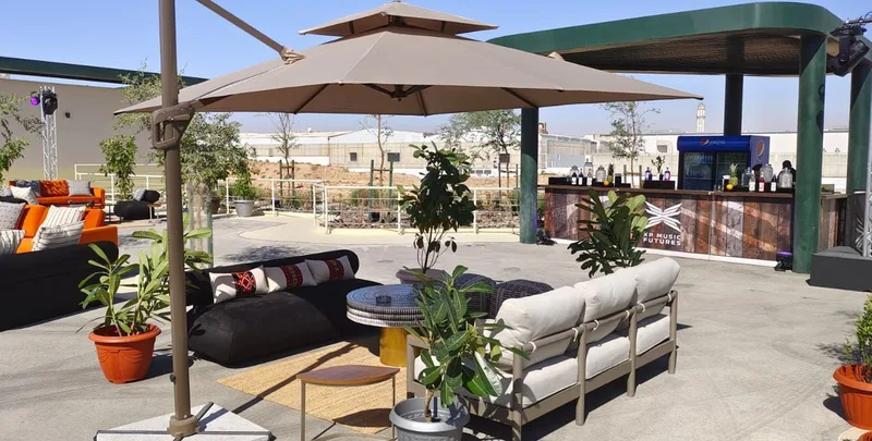 Outdoor networking lounge with armchairs, bean bags, pouffes and shaded seating zones