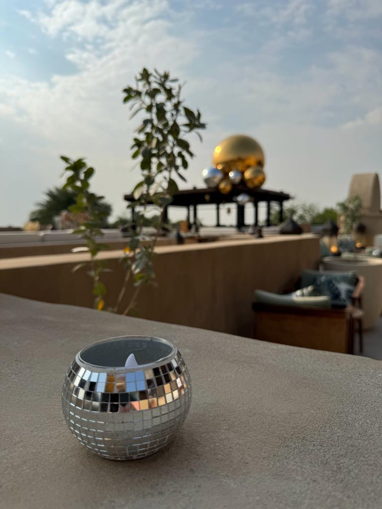 Mirrored sphere cluster with decorative lantern accents for Bab Al Shams festive styling.
