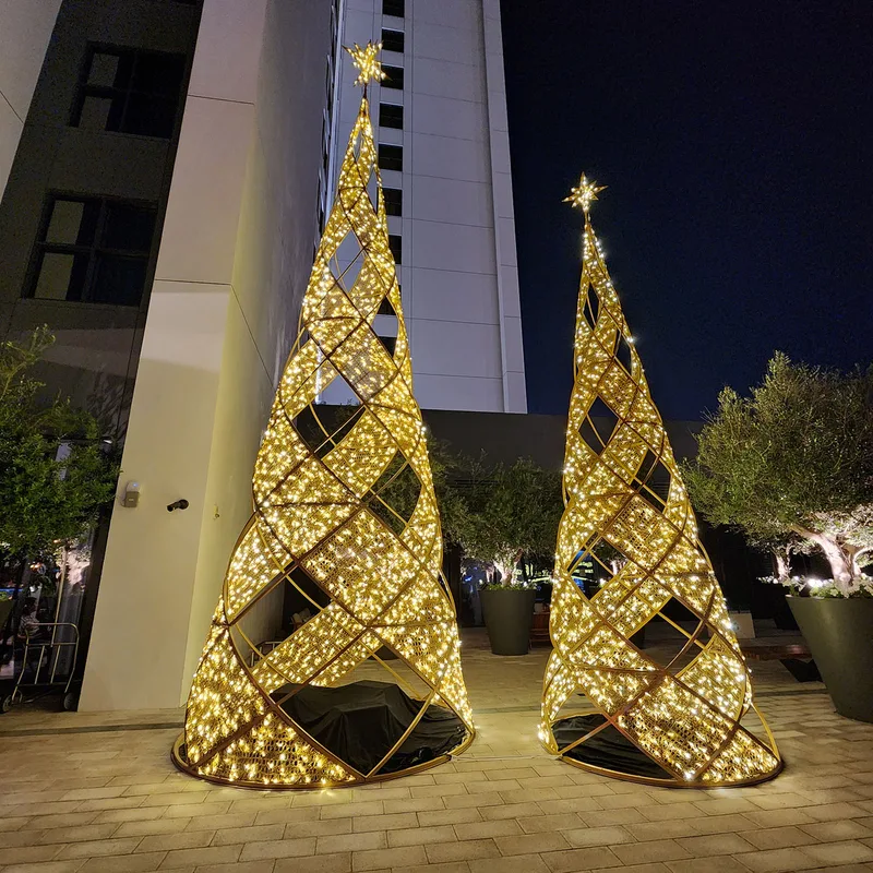 Contemporary geometric Christmas tree props illuminated with warm white decorative lighting