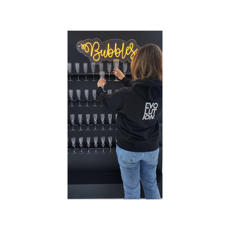 P-PV101-BL Bubbles beverage display wall in white, holds 52 glasses in black, with glossy finish and LED sign