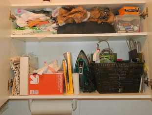 laundry room cabinet before organzing